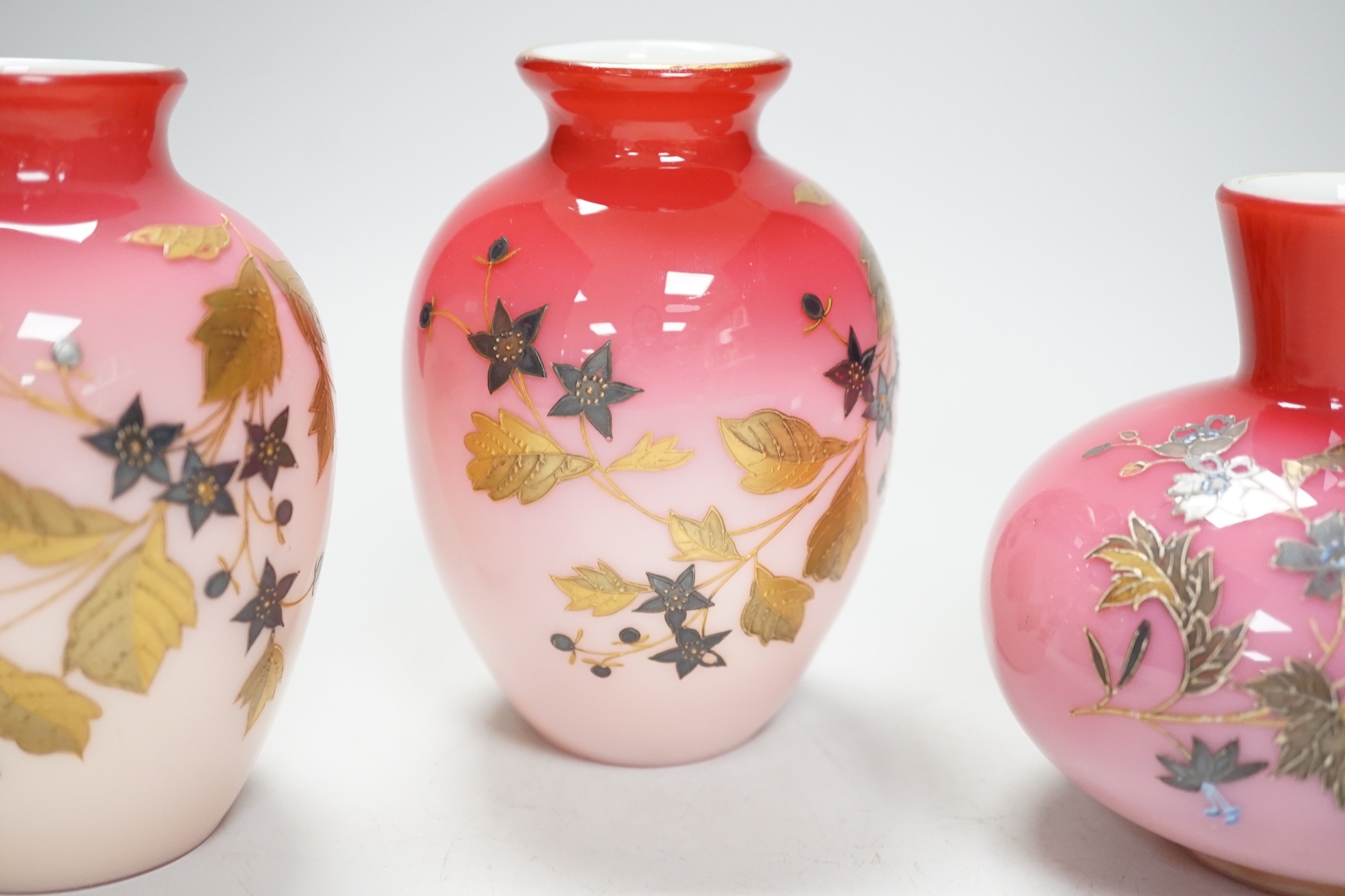 A pair of Stourbridge peach blow vases and another, tallest 13cm